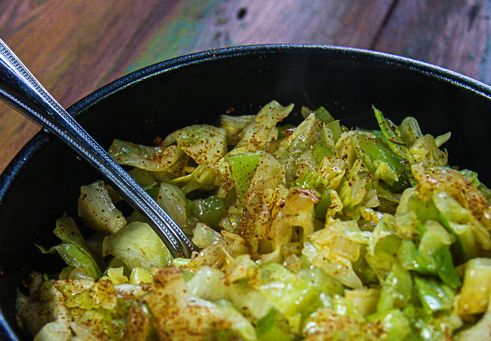 Southern fried cabbage in bowl with spoon
