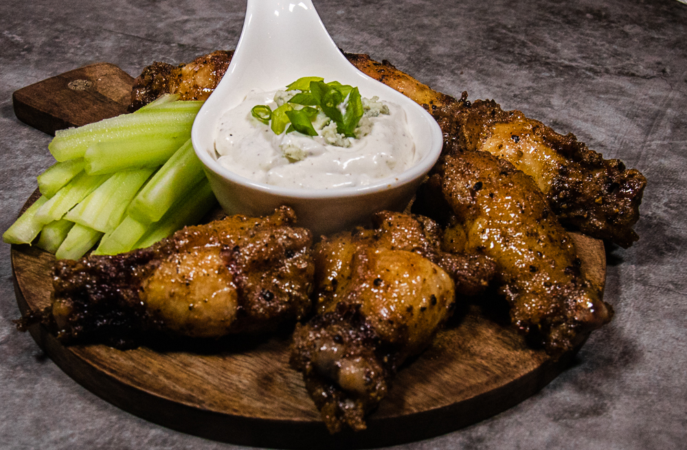 Spicy pepper buffalo wings on on serving tray