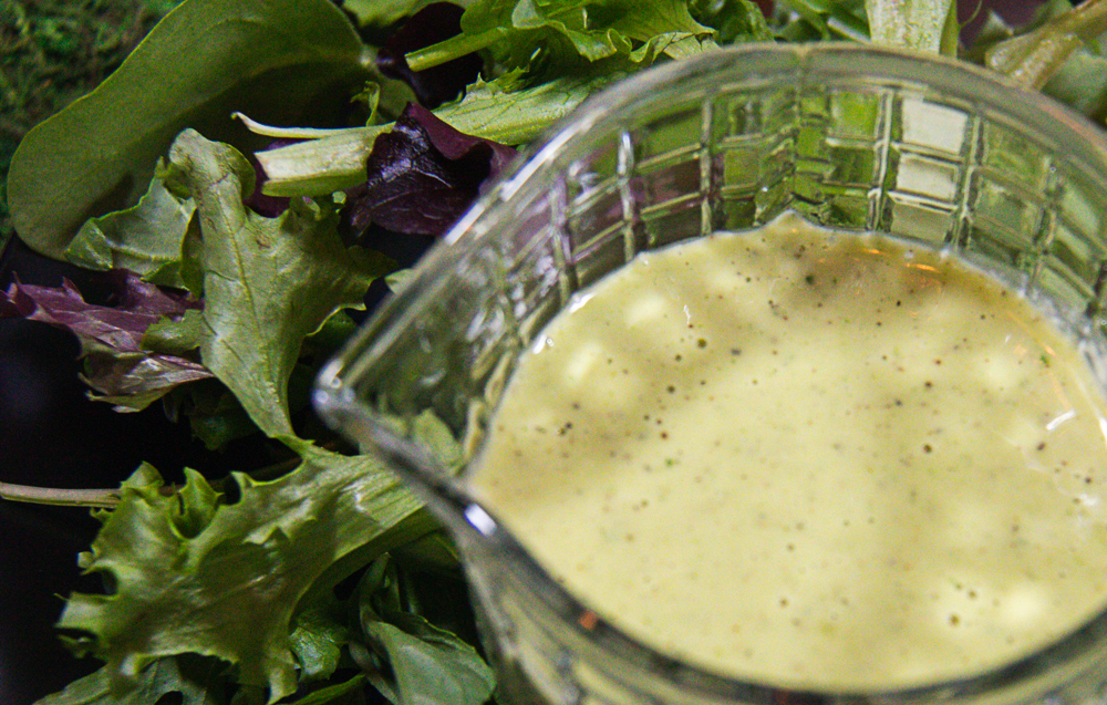 Fresh Basil Vinaigrette in pitcher with salad
