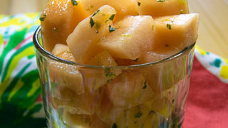 melon salad with lime dressing in a glass bowl