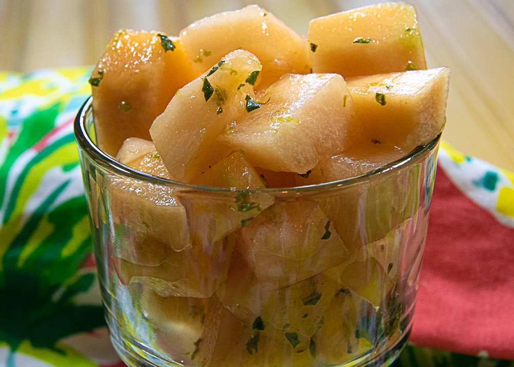 melon salad with lime dressing in a glass bowl