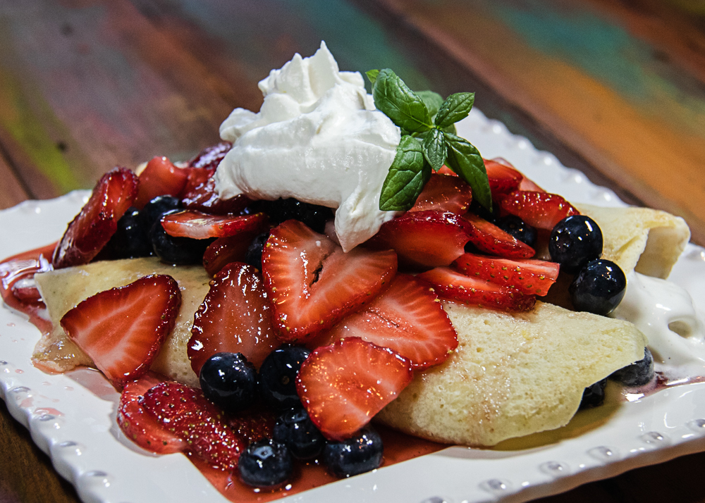 easy berry crepes on a plate