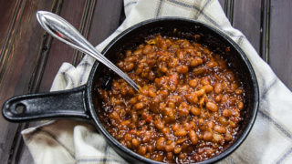 Easy cowboy baked beans in dish with spoon