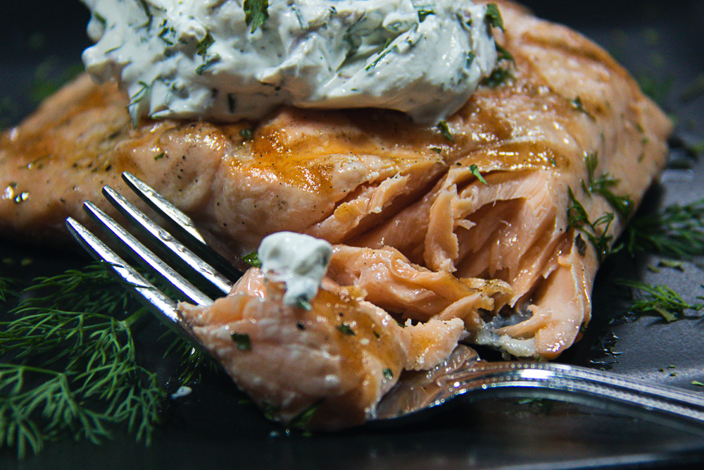 Grilled salmon with shallot dill sauce on fork