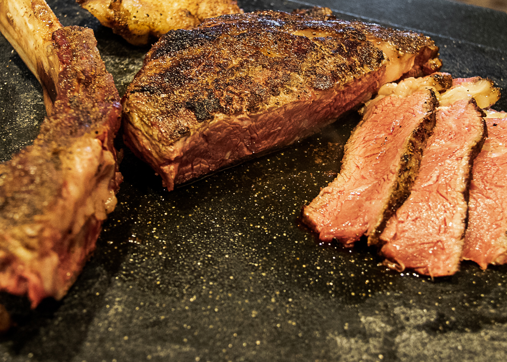 smoked tomahawk steak on cutting board