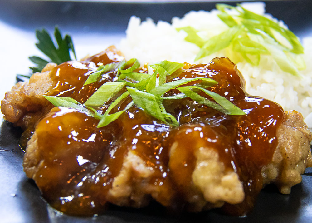 Chinese orange chicken on plate with rice