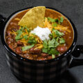 easy chili in bowl with garnishes