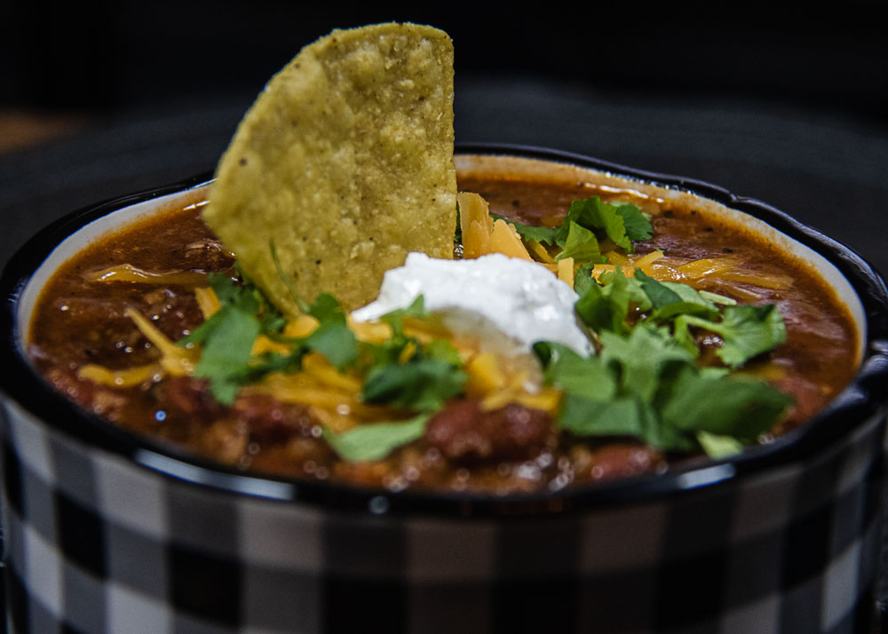 easy chili with tortilla chip and garnish