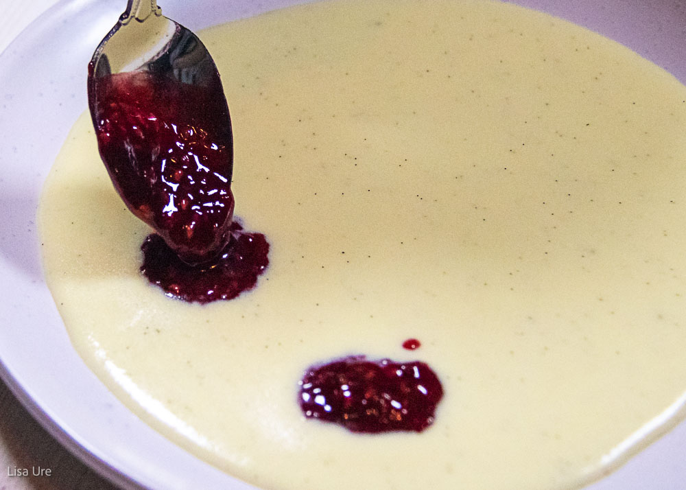 raspberry sauce dolloped on puddle of creme anglaise