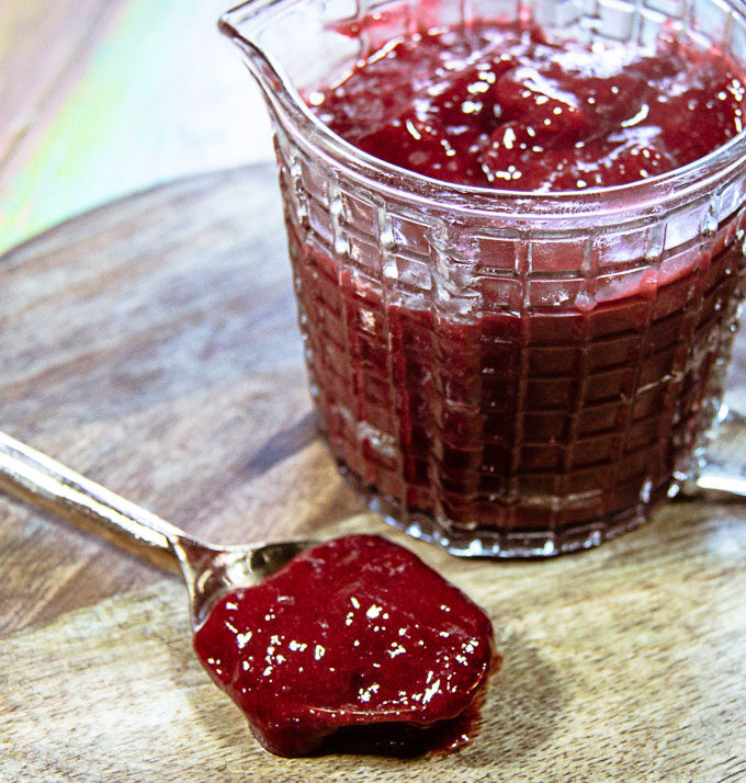 raspberry coulis in serving container and on spoon