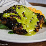 Peruvian Chicken with green sauce on a plate