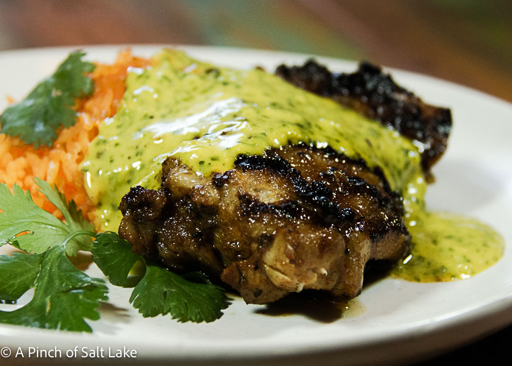 closeup of peruvian chicken with green sauce