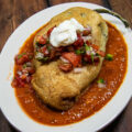 chile Rellenos with salsa roja on platter