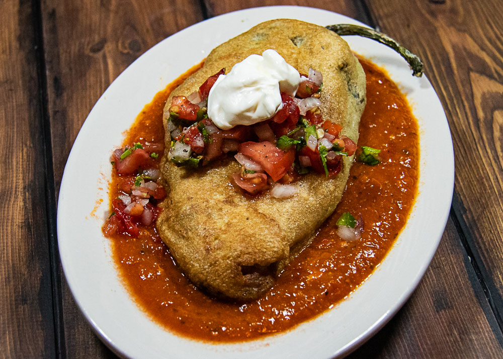 chile Rellenos with salsa roja on platter
