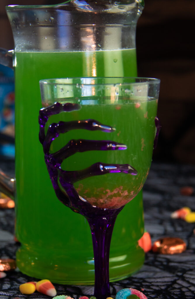 Ectoplasm Halloween drink with pop rocks sinking to the bottom of a spooky cup