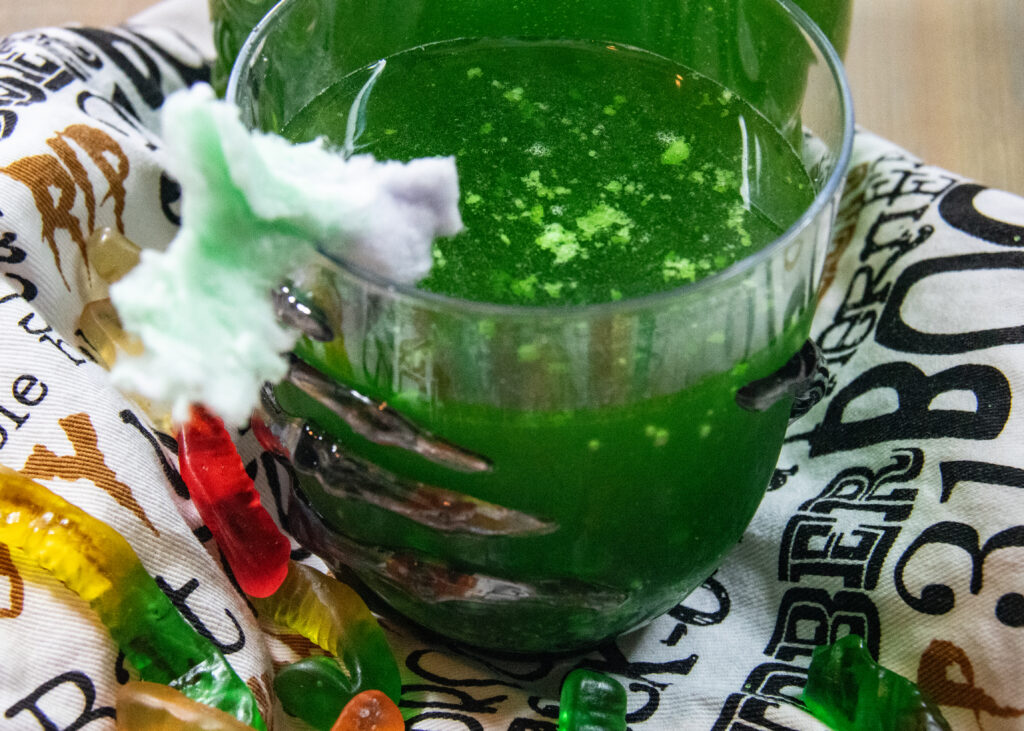 Ectoplasm Halloween drink garnished with cotton candy.